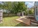 Backyard with wooden fence, shed, and a patio area perfect for outdoor entertaining at 1019 Richard St, Salisbury, NC 28144