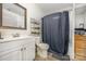 Bathroom features a shower-tub combo with gray curtain and a white sink vanity at 1019 Richard St, Salisbury, NC 28144