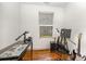 Bedroom features wood floors and window with mini blinds for natural light at 1019 Richard St, Salisbury, NC 28144