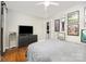 Bedroom features hardwood floors, ceiling fan, gallery wall, and black dresser at 1019 Richard St, Salisbury, NC 28144