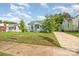 Quaint light blue home with a walkway, grassy lawn, and mature trees at 1019 Richard St, Salisbury, NC 28144