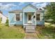 Charming light blue home with a welcoming front porch and well-maintained lawn at 1019 Richard St, Salisbury, NC 28144