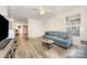 Spacious living room showcasing hardwood floors, a blue sofa, and neutral decor at 1019 Richard St, Salisbury, NC 28144