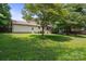 Large backyard with mature trees, covered deck, and full lawn is perfect for entertaining friends and Gathering at 10206 Washam Potts Rd, Cornelius, NC 28031
