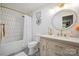 Elegant bathroom with white vanity, brushed gold fixtures, and tiled shower at 10206 Washam Potts Rd, Cornelius, NC 28031
