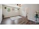Bedroom featuring hardwood floors, two windows, and a ceiling fan at 10206 Washam Potts Rd, Cornelius, NC 28031