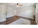 Bedroom with hardwood floors, ceiling fan, and a view of the hallway at 10206 Washam Potts Rd, Cornelius, NC 28031