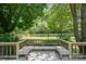 Enjoy the custom deck with built in seating and private backyard with lush lawn and mature trees at 10206 Washam Potts Rd, Cornelius, NC 28031