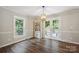 Bright dining room featuring hardwood floors, built in shelves, and double doors to outdoor deck at 10206 Washam Potts Rd, Cornelius, NC 28031