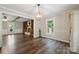 Charming dining room with hardwood floors, chandelier, and built-in shelving fireplace at 10206 Washam Potts Rd, Cornelius, NC 28031