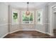 Bright dining area with bay windows, hardwood floors, and ample natural light at 10206 Washam Potts Rd, Cornelius, NC 28031