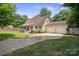 Charming home featuring a well-manicured lawn and a convenient two-car garage at 10206 Washam Potts Rd, Cornelius, NC 28031