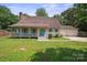 Beautiful home featuring a covered front porch, lush lawn, and a spacious two-car garage at 10206 Washam Potts Rd, Cornelius, NC 28031