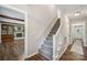 Inviting foyer with hardwood floors, staircase, and view to the living room at 10206 Washam Potts Rd, Cornelius, NC 28031