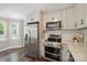 Well-designed kitchen with stainless steel appliances, quartz countertops, and modern fixtures at 10206 Washam Potts Rd, Cornelius, NC 28031