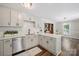 Bright and airy kitchen featuring stainless steel appliances, quartz countertops, and a stylish backsplash at 10206 Washam Potts Rd, Cornelius, NC 28031
