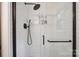 Modern shower with sleek subway tile, glass door, and convenient shelving at 10206 Washam Potts Rd, Cornelius, NC 28031