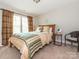 Cozy bedroom features a bed, curtains and two windows providing natural light at 1109 Saratoga Blvd, Indian Trail, NC 28079