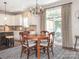 Bright dining area with wood table, stylish rug, and sliding doors to outdoor patio at 1109 Saratoga Blvd, Indian Trail, NC 28079