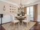 Chic dining room with a round table set for four, complemented by elegant decor and natural light at 1109 Saratoga Blvd, Indian Trail, NC 28079