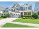 Charming two-story home with a well-manicured lawn and a two-car garage at 1109 Saratoga Blvd, Indian Trail, NC 28079