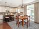 Eat-in kitchen features stainless appliances, granite counters, an island, and access to the patio at 1109 Saratoga Blvd, Indian Trail, NC 28079