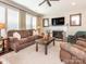 Inviting living room featuring a cozy fireplace, plush seating, and ample natural light at 1109 Saratoga Blvd, Indian Trail, NC 28079