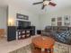 Comfortable living room featuring a large TV and two sofas with a ceiling fan at 1109 Saratoga Blvd, Indian Trail, NC 28079