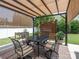 Outdoor patio area with a dining table, chairs, pergola, and privacy screen at 1109 Saratoga Blvd, Indian Trail, NC 28079