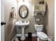 Charming powder room with pedestal sink, decorative mirror, and stylish fixtures at 1109 Saratoga Blvd, Indian Trail, NC 28079