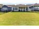 Well-maintained backyard featuring a spacious lawn and covered patio, perfect for outdoor enjoyment and entertaining at 1120 Idyllic Ln, Waxhaw, NC 28173