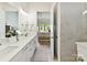 Bathroom featuring double sinks with white countertops and a view into the main bedroom at 1120 Idyllic Ln, Waxhaw, NC 28173