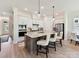 Kitchen island with seating, stainless appliances, and a decorative backsplash at 1120 Idyllic Ln, Waxhaw, NC 28173