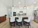 Kitchen island with marble countertops, seating, pendant lighting, and stainless steel appliances at 1120 Idyllic Ln, Waxhaw, NC 28173