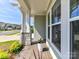 View of covered porch with wood flooring and stone support columns at 1120 Idyllic Ln, Waxhaw, NC 28173