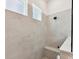 Shower featuring neutral tiling, a built-in bench, and a window for natural light at 1120 Idyllic Ln, Waxhaw, NC 28173