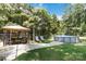 Backyard view featuring patio with outdoor seating, gazebo, and above ground pool at 1219 Flowe Dr, Matthews, NC 28104
