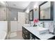 Bathroom with dual sinks, modern vanity, walk-in shower, and sleek fixtures at 1219 Flowe Dr, Matthews, NC 28104