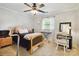 Well lit bedroom with window, ceiling fan, closet, desk, and chair at 1219 Flowe Dr, Matthews, NC 28104