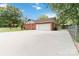 Exterior view of house with wide driveway and two car garage at 1219 Flowe Dr, Matthews, NC 28104