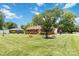 Beautiful well-maintained lawn and landscaping surround a charming brick home on a sunny day at 1219 Flowe Dr, Matthews, NC 28104