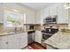 Modern kitchen with stainless steel appliances, granite countertops, and white cabinets at 1219 Flowe Dr, Matthews, NC 28104