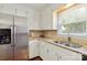 Kitchen features stainless steel refrigerator, double sinks, granite countertops, and custom cabinets at 1219 Flowe Dr, Matthews, NC 28104