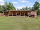 Large covered porch is ideal for entertaining, with a covered carport on the side at 130 Benton Rd, Kings Mountain, NC 28086