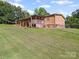Spacious backyard featuring a large covered deck, perfect for outdoor entertaining at 130 Benton Rd, Kings Mountain, NC 28086