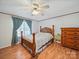 Comfortable bedroom with hardwood floors, a large window, and a traditional wood bed frame at 130 Benton Rd, Kings Mountain, NC 28086