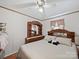 Traditional bedroom features a queen sized bed, ceiling fan, and plenty of space for storage with a large dresser at 130 Benton Rd, Kings Mountain, NC 28086