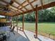 Covered deck with seating overlooking a large backyard at 130 Benton Rd, Kings Mountain, NC 28086