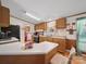 The kitchen with wooden cabinets features a breakfast bar and modern appliances with an adjacent eating area at 130 Benton Rd, Kings Mountain, NC 28086