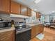 Well-lit kitchen boasts wood cabinets, stainless steel oven and laminate countertops, adjacent to a cozy dining area at 130 Benton Rd, Kings Mountain, NC 28086